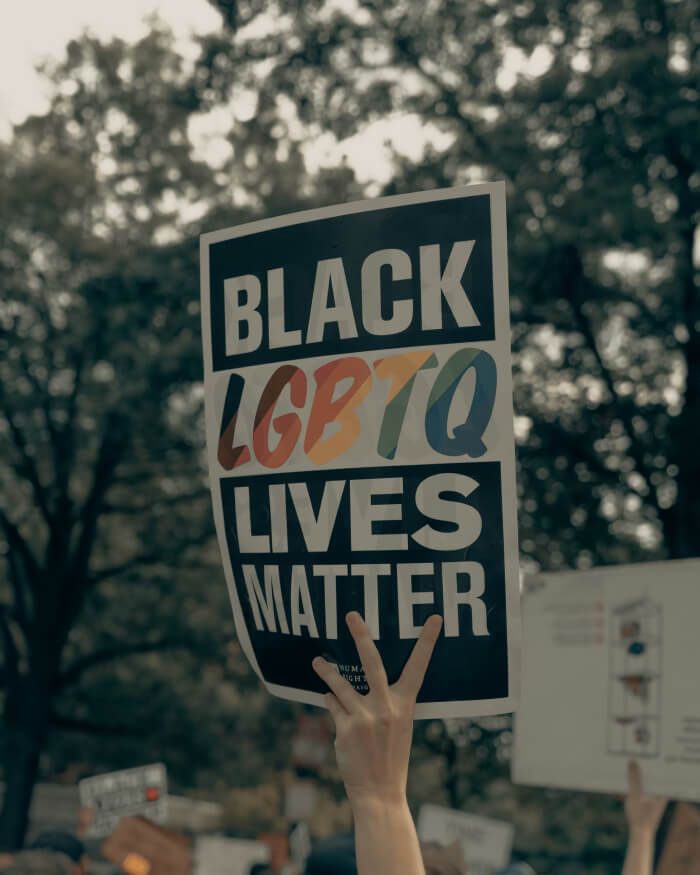 Hand holding up Black LGBTQ Lives Matter